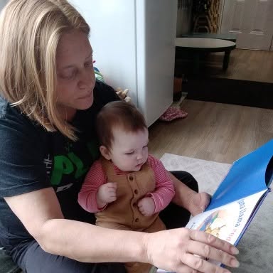 Ms. Lisa reading with a baby