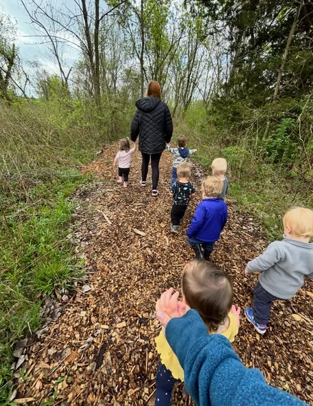 Teacher and children walking together on the Macomb forest trail