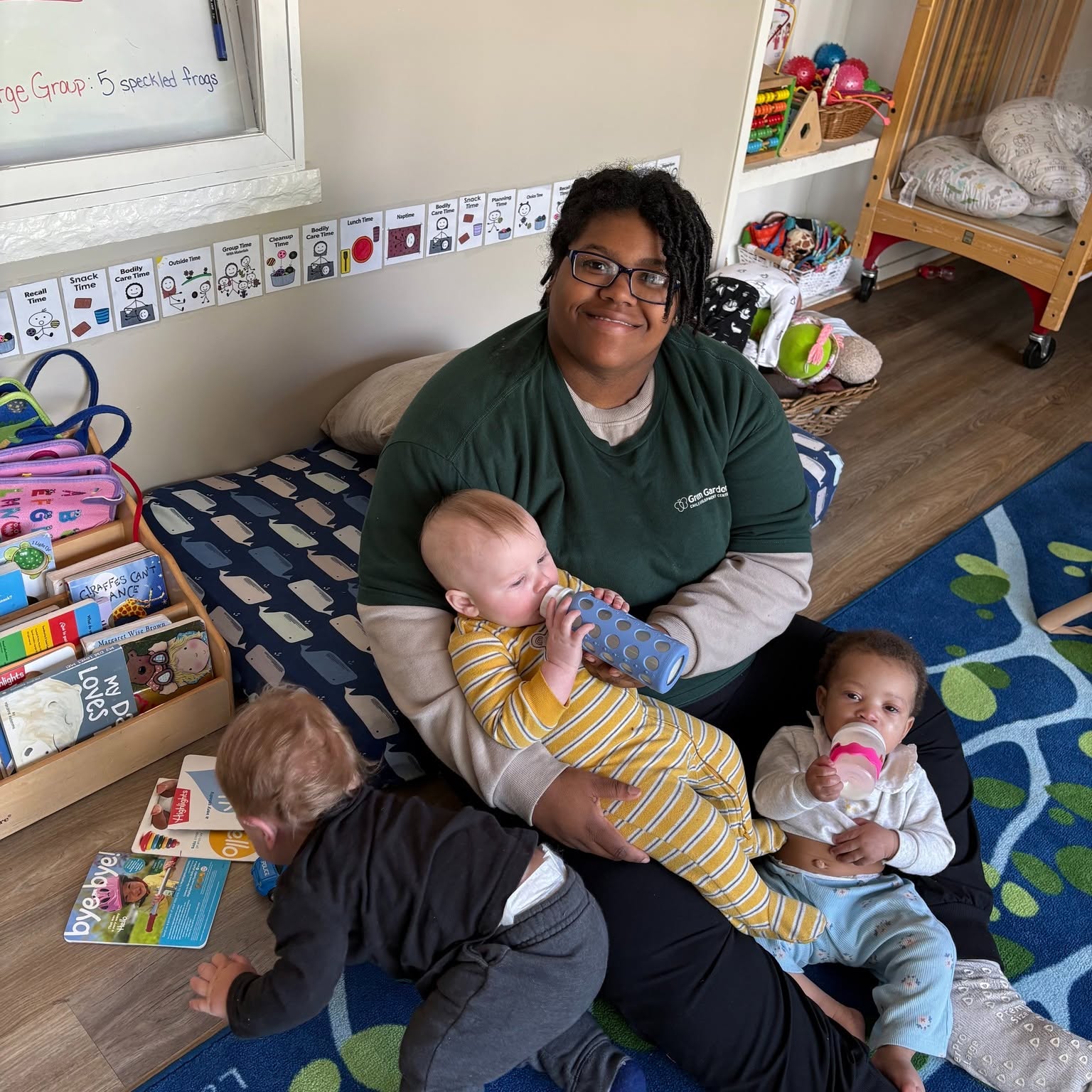 Ms. Kyra with children in the infant classroom