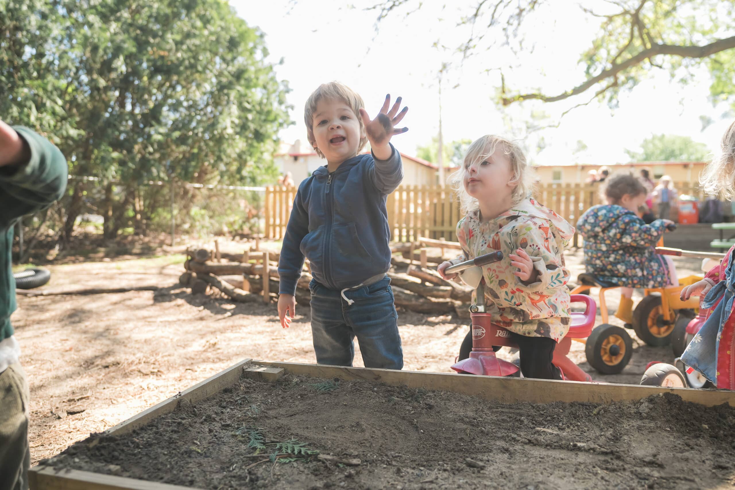 Children investigating a raised outdoor play area